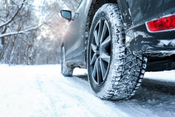 A car on snow filled road.